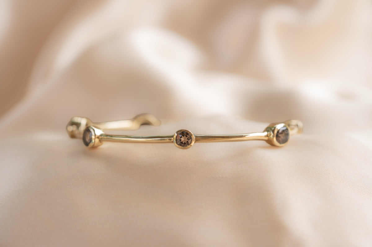 Aurelia Smoulder Bangle handmade brass bracelet with smokey quartz stone — Land of Sundara
