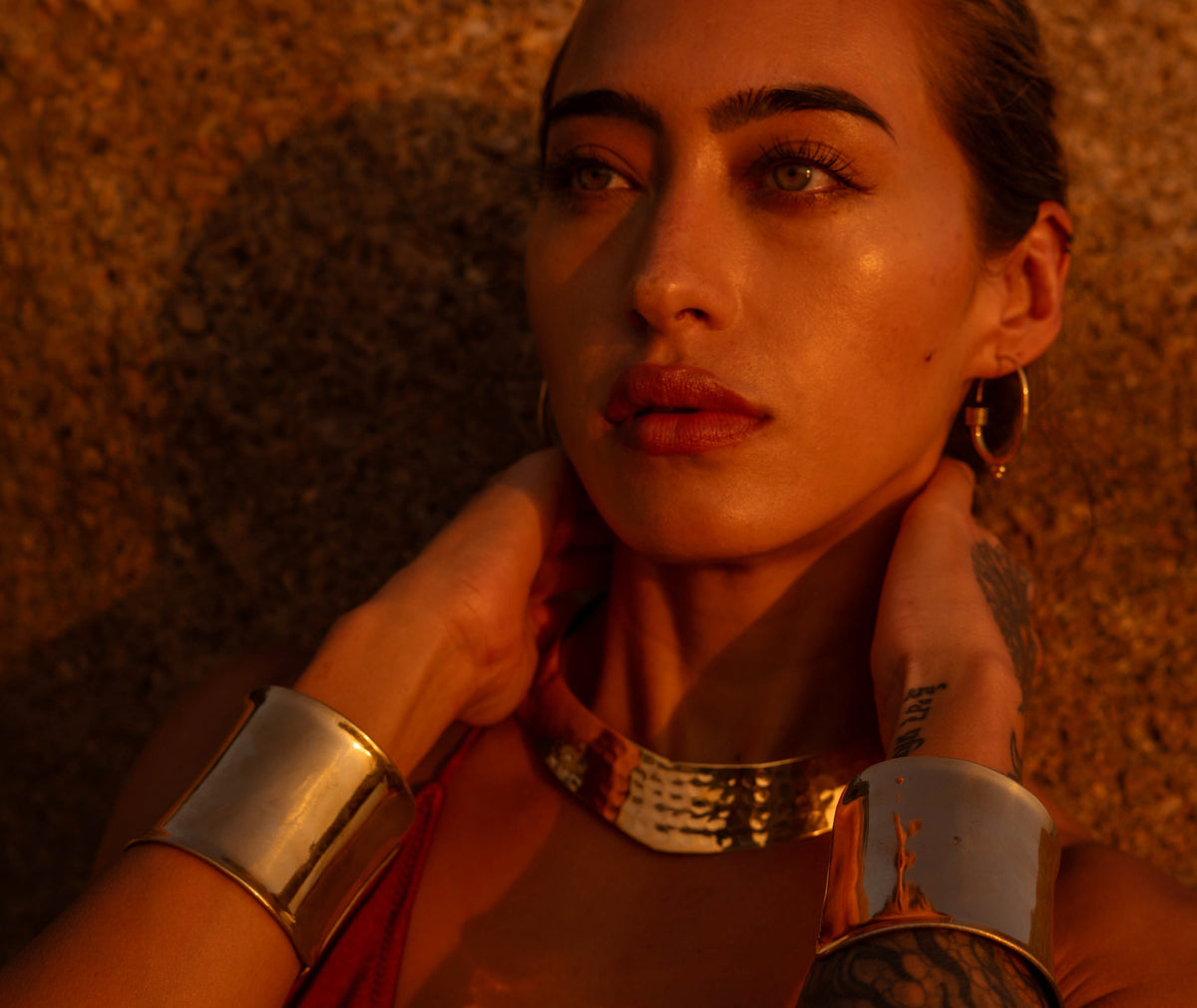 Hand-hammered Land of Sundara brass jewelry detail, warmed by golden hour light — Our Story